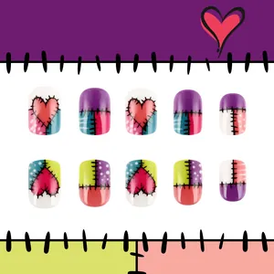 Short glossy press-on nails with colorful heart patchwork and Sally inspired stitch design