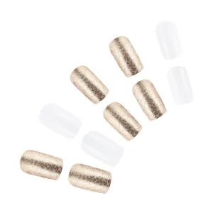 Close-up of champagne gold glitter and glossy white press-on nails in square shape