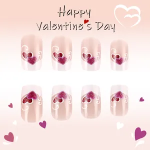 Short square press-on nails with purple French tips and pink glitter heart designs