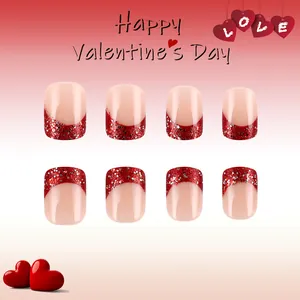 Detail of red glitter French tip press-on nails with Happy Valentine's Day theme