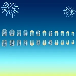 Faux ongles courts ovales dégradés bleus avec motifs de feux d'artifice et strass brillants