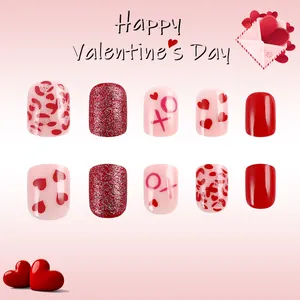 Short red heart press-on nails with XO pattern and glitter for Valentine's Day