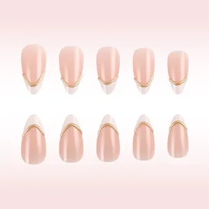 Detail of 10-piece almond press-on nails with nude pink base and 3D gold wavy stripes