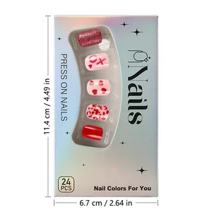 Close-up of red glitter and heart pattern press-on nails with holographic packaging box