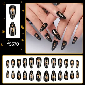 Elegant black almond press-on nails with golden star and moon patterns for a chic festive look
