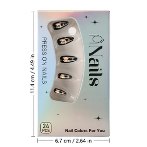 Detail view of almond press-on nails with black gold star moon design in holographic box