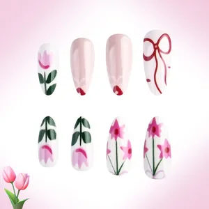 Detailed view of hand-painted stiletto press-on nails with pink tulips and ribbon designs