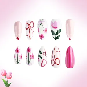 Detailed view of pink floral tulip and red bow hand-painted glossy press-on nails