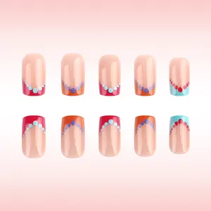 Close-up of short square colorful French dot press-on nails with glossy finish