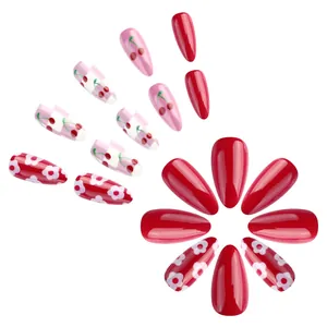 Almond shaped press-on nails in glossy red cherry patterns and checkerboard designs