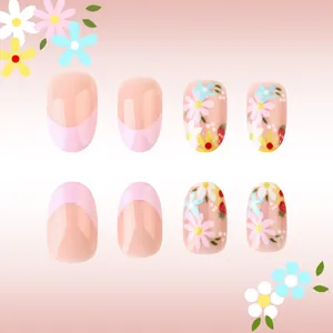 Close-up of pink French press-on nails with daisy and strawberry floral patterns