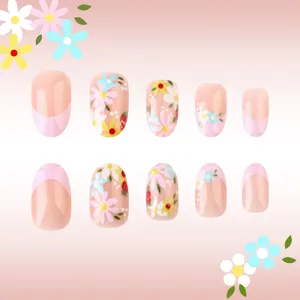 Detail of short oval pink French nails with small colorful daisy floral patterns