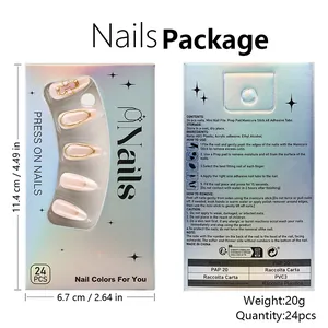 Macro detail of press-on nails set featuring golden floral edges and pink 3D bow accents