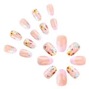 Short oval pink French fake nails with floral patterns and glossy glitter finish