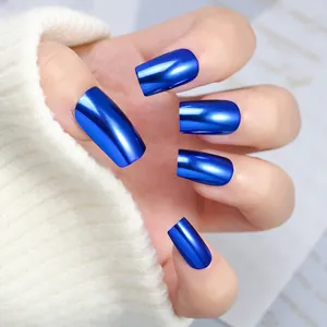 Detail view of metallic blue press-on nails on hands with white knit sweater background