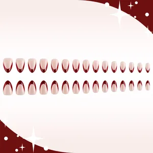 French almond press-on nails in nude pink with deep burgundy tips and glossy finish
