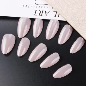 Macro view of medium almond cat-eye press-on nails in shimmer nude pink with moonlight finish
