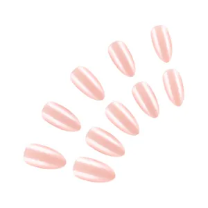 Macro detail of glossy light pink almond press-on nails with elegant pearlescent finish