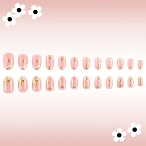 Pink press-on nails with gold leaf patterns and white 3D flowers in a 24-piece set