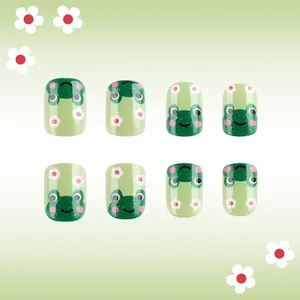 Short glossy green press-on nails with cute frog and flower patterns for spring