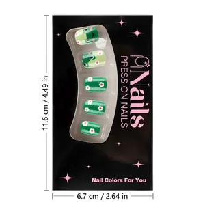 Detail of green press-on nails with frog and flower designs in branded packaging