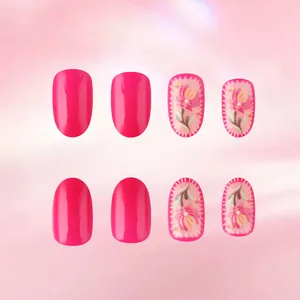 Detail of pink press-on nails featuring 3D embossed flowers and glossy magenta finish