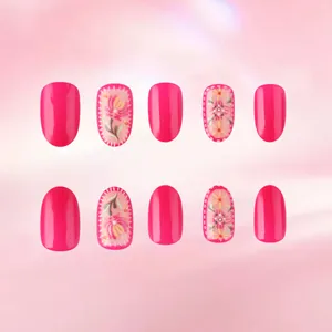 Detail of pink press-on nails featuring 3D embossed floral patterns and glossy finish
