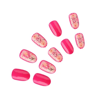 Detailed macro view of pink floral press-on nails with 3D embossed flower art designs
