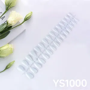 Glossy white almond press-on nails set with elegant floral background for women