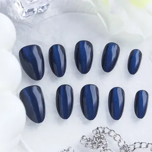Glossy dark blue cat-eye press-on nails in oval shape for an elegant manicure