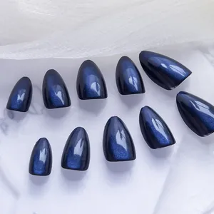 Macro view of deep sapphire blue cat eye almond nails with shimmering gloss finish