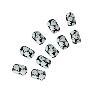 Detail of 10-piece Halloween press-on nails with white glitter ghosts on black base