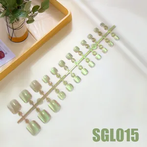 Icy mint green cat eye press-on toenails with 24-piece set on white tray