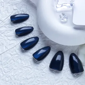 Midnight blue cat-eye almond press-on nails with shimmering finish on a white display
