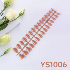 Flat lay of warm orange almond press-on nails set with 24 pieces in a neat arrangement