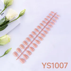Macro view of 24 pieces nude pink almond press-on nails with glossy finish on plastic strip