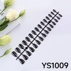 Detail of 24 pieces set of glossy black almond shaped medium press on nails on a tray