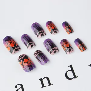 Detailed close-up of 10pcs Halloween press-on nails with purple forest and tombstone art
