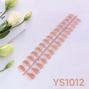 Flat lay of 24pcs glossy pink almond press-on nails set with elegant floral props