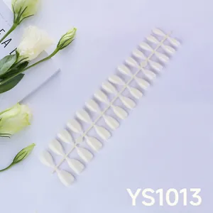 Detailed close-up of pearl white almond press-on nail tips on a display card YS1013