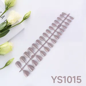 Macro view of 24 pieces almond-shaped glossy dusty pink press-on nails set on white background