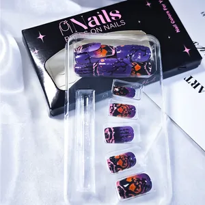 Macro detail of Halloween press-on nails with purple gradient and dark forest silhouettes