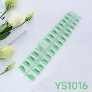 Detailed view of light green almond press-on nails set on a plastic frame