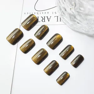 Short square cat eye press-on nails in golden brown and olive green shimmering finish