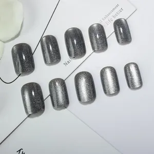 Short square grey cat eye press-on nails with sparkling glitter effect on white display
