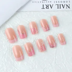 Square press-on nails with pink floral patterns, French tips and glitter accents
