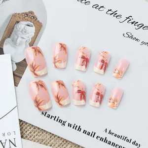 Detail of short square press-on nails with autumn maple leaf designs and gold glitter accents