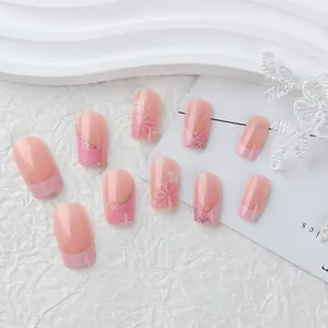 Detail of pink floral square press-on nails with glitter accents and geometric patterns