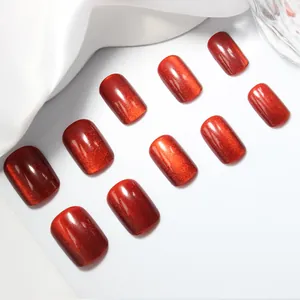 Macro shot of red cat-eye press-on nails with glitter finish and square-oval shape