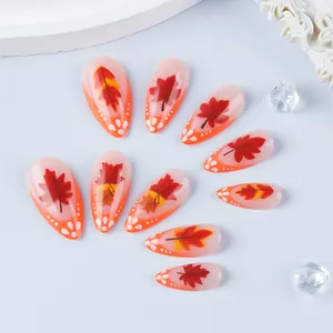 Glossy almond press-on nails featuring orange French tips and autumn maple leaf designs